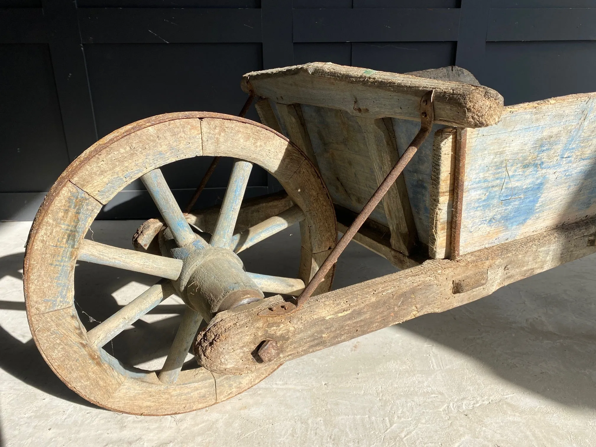 Washed out blue French wooden wheelbarrow