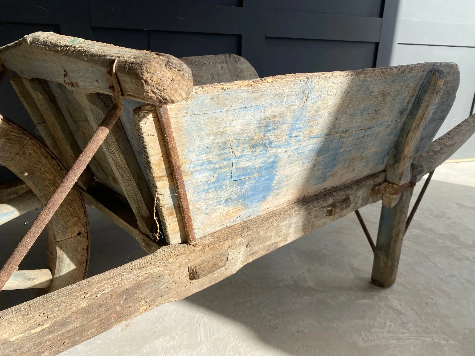 Washed out blue French wooden wheelbarrow