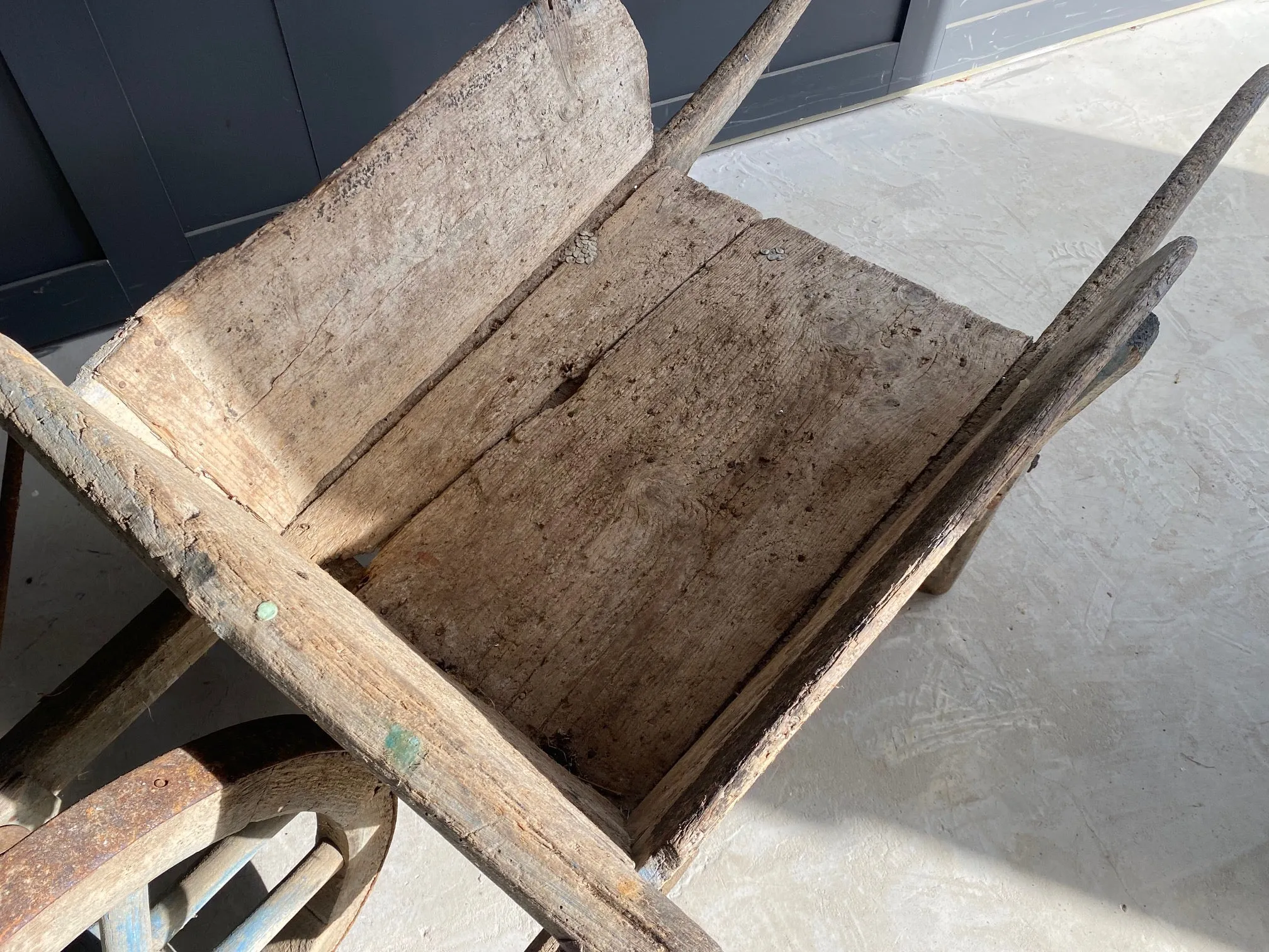 Washed out blue French wooden wheelbarrow