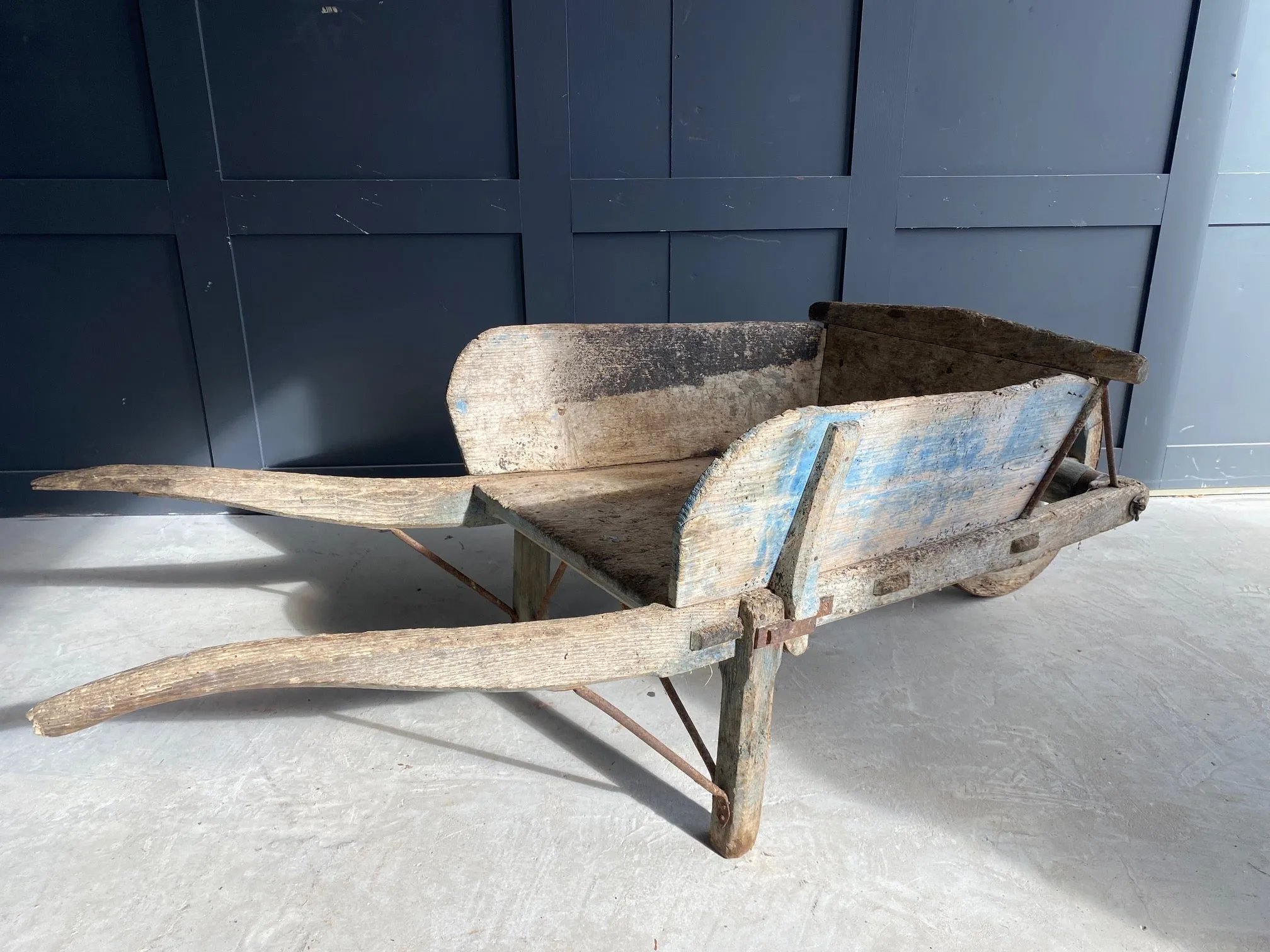 Washed out blue French wooden wheelbarrow